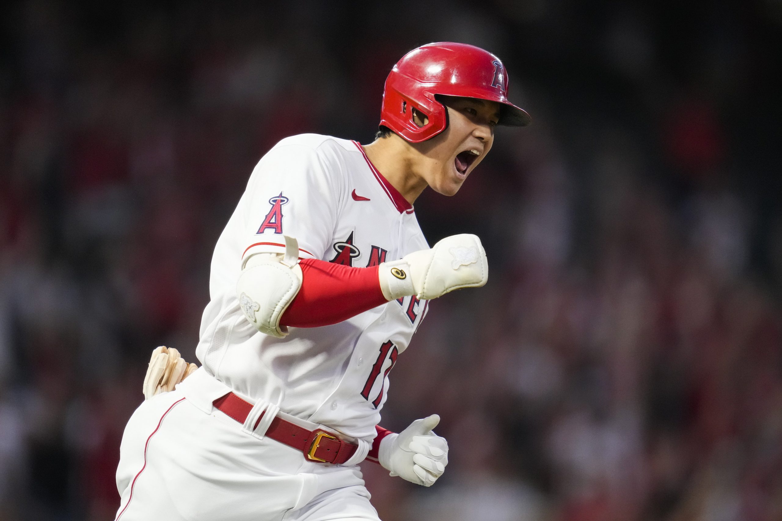 Los Angeles Angels designated hitter Shohei Ohtani (17) reacts as he runs the bases after hitting a home run during the fourth inning of a baseball game against the Baltimore Orioles Friday, July 2, 2021, in Anaheim. David Fletcher also scored.