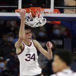 Gonzaga center Chet Holmgren reacts after his dunk during the first half of an NCAA college basketball game against Bellarmine, Friday, Nov. 19, 2021, in Spokane, Wash.