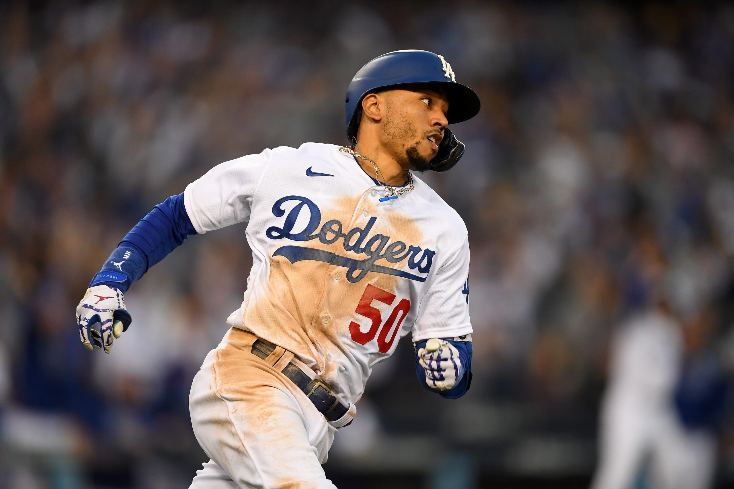 Los Angeles Dodgers right fielder Mookie Betts (50) hits a RBI double in the eighth inning of game three of the 2021 NLCS against the Atlanta Braves at Dodger Stadium