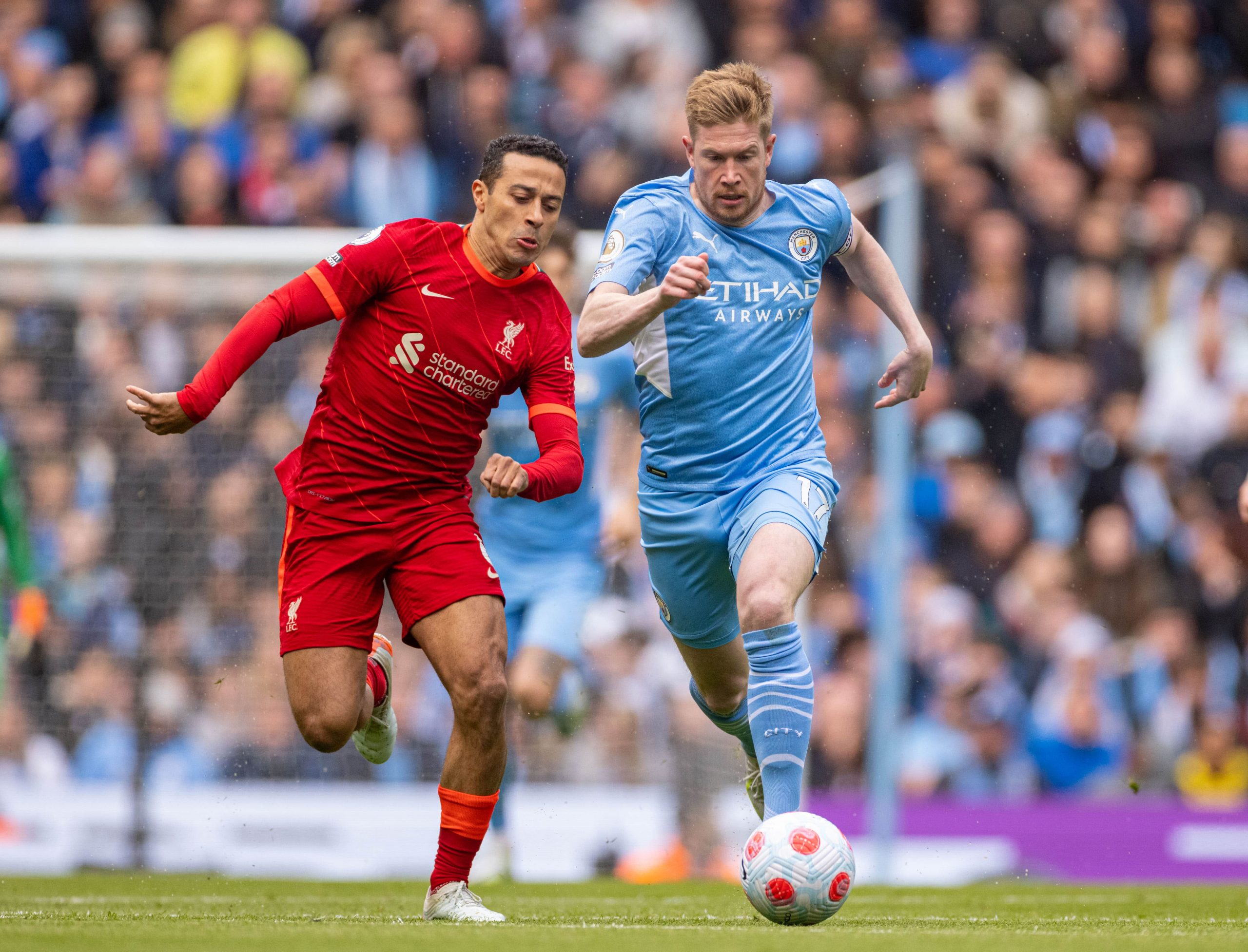Manchester City's Kevin de Bruyne (R) gets away from Liverpool's Thiago Alcantara during the English Premier League match between Manchester City and Liverpool in Manchester, Britain, on April 10, 2022. The game ended in a 2-2 draw.