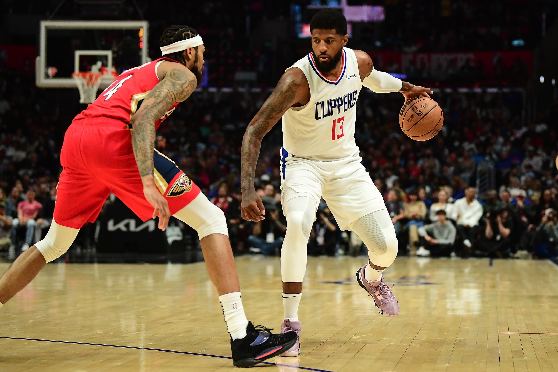 Los Angeles Clippers guard Paul George (13) controls the ball against New Orleans Pelicans forward Brandon Ingram (14) during the second half at Crypto.com Arena.