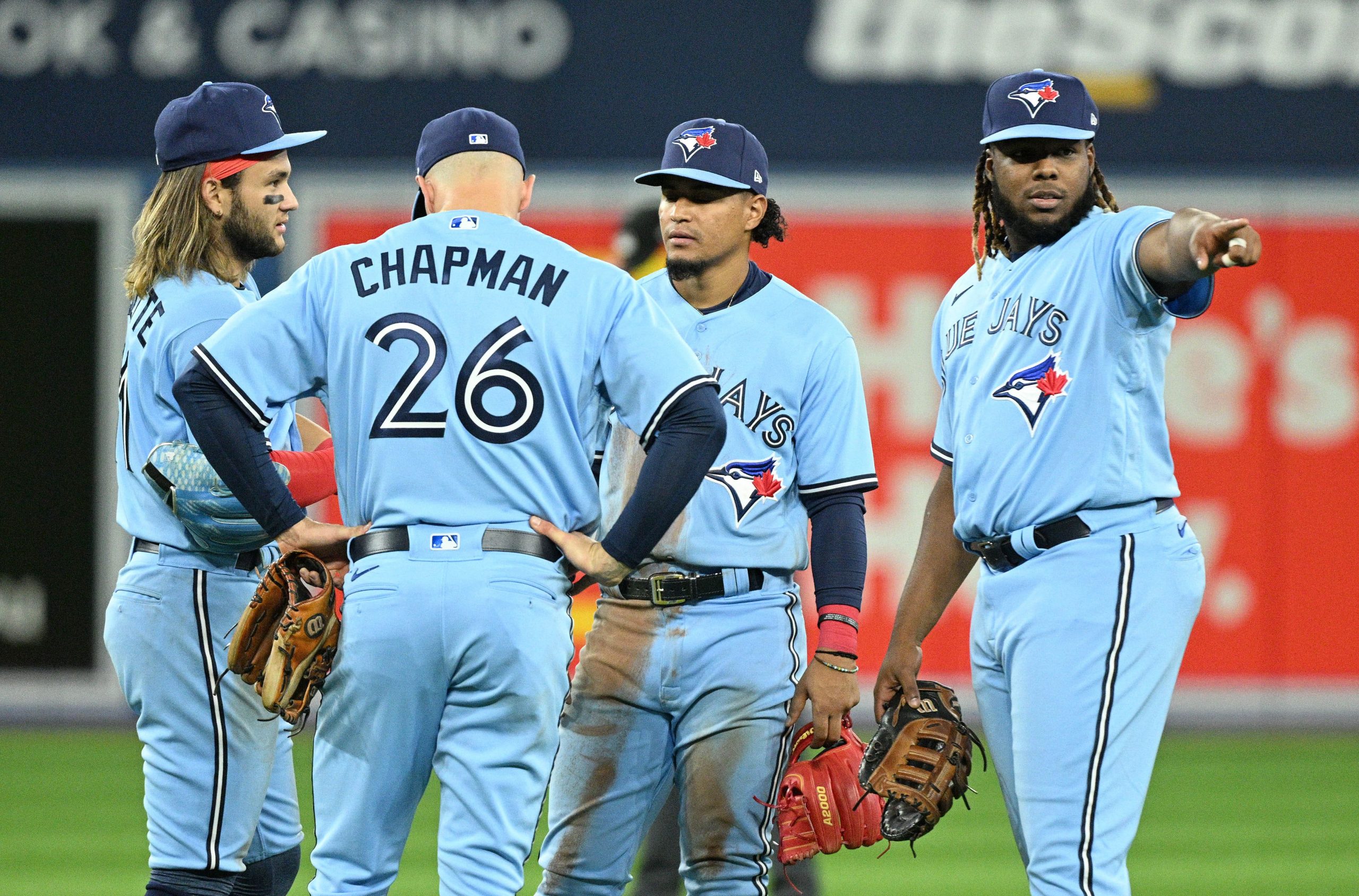 Toronto Blue Jays first baseman Vladimir Guerrero Jr. (27) gestures as he speaks with second baseman Santiago Espinal (5) and third baseman Mark Chapman (26) and shortstop Bo Bichette (11) in the eighth inning against the Oakland Athletics at Rogers Centre.