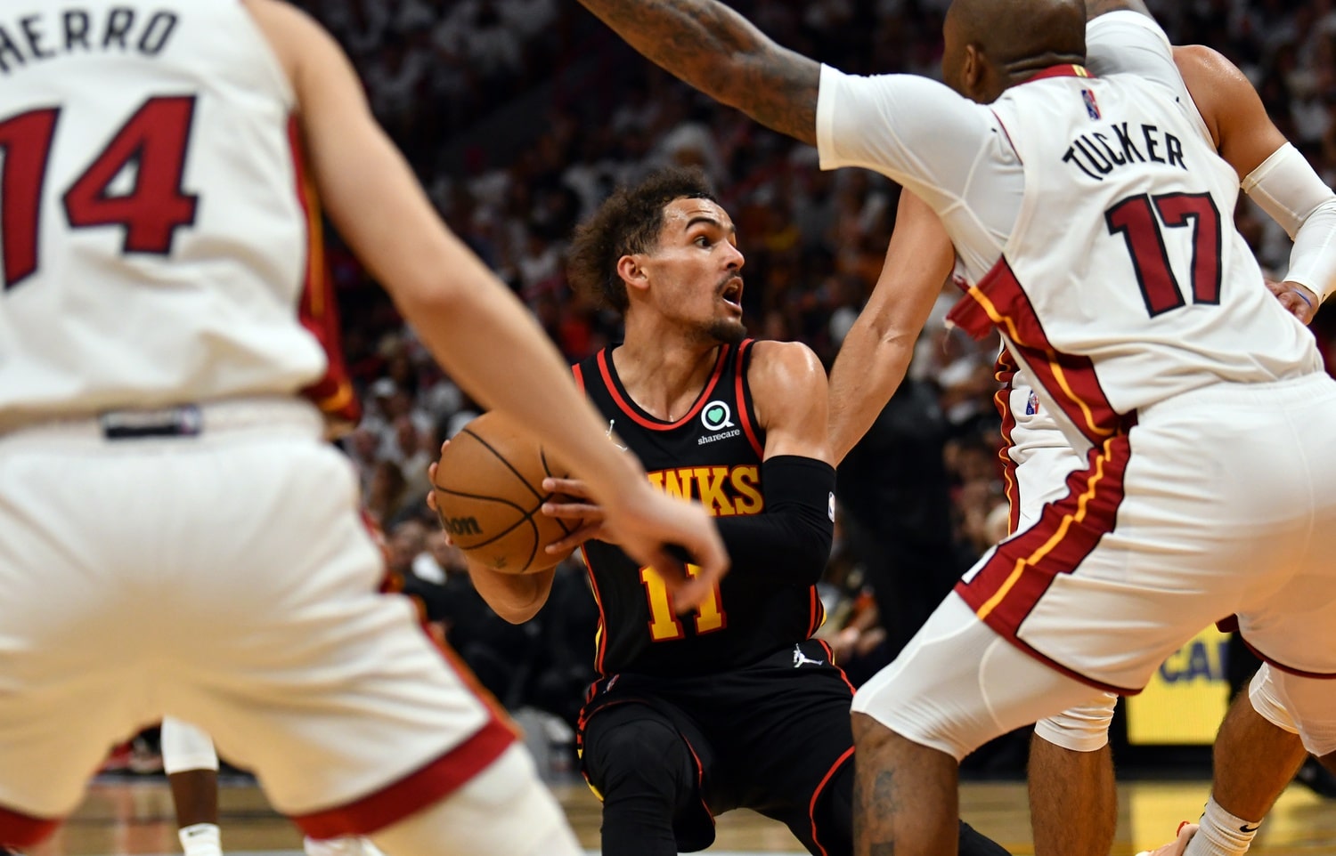 Atlanta Hawks guard Trae Young (11) looks to pass the ball as Miami Heat forward P.J. Tucker (17) and teammate guard Tyler Herro (14) defend during the second half of game one of the first round for the NBA playoffs.