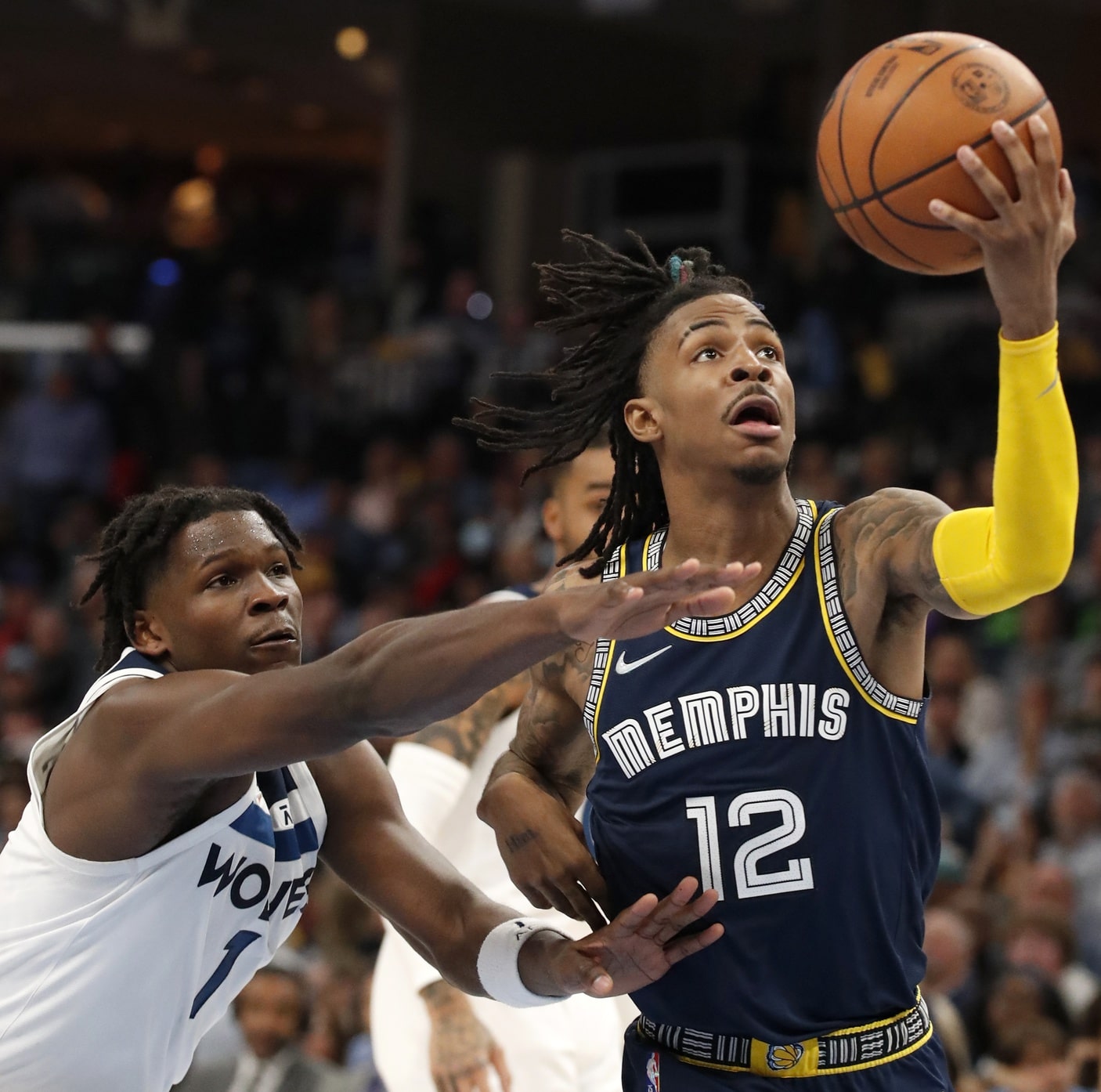 Memphis Grizzlies guard Ja Morant (12) is guarded by Minnesota Timberwolves forward Anthony Edwards (1) as he goes to shoot the ball during the second half of game two of the first round for the 2022 NBA playoffs.