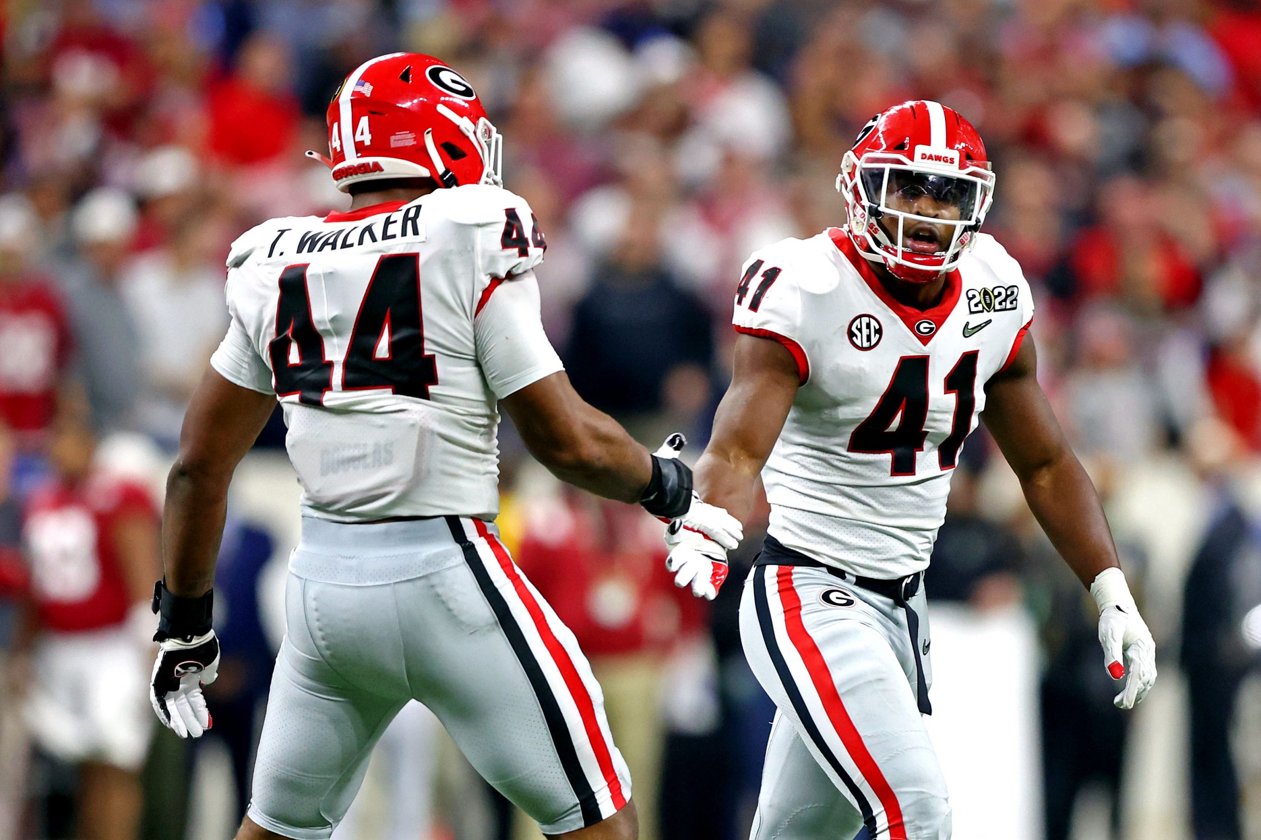 Georgia Bulldogs linebacker Channing Tindall (41) celebrates with Georgia Bulldogs defensive lineman Travon Walker (44) during the first half against the Alabama Crimson Tide in the 2022 CFP college football national championship game at Lucas Oil Stadium.
