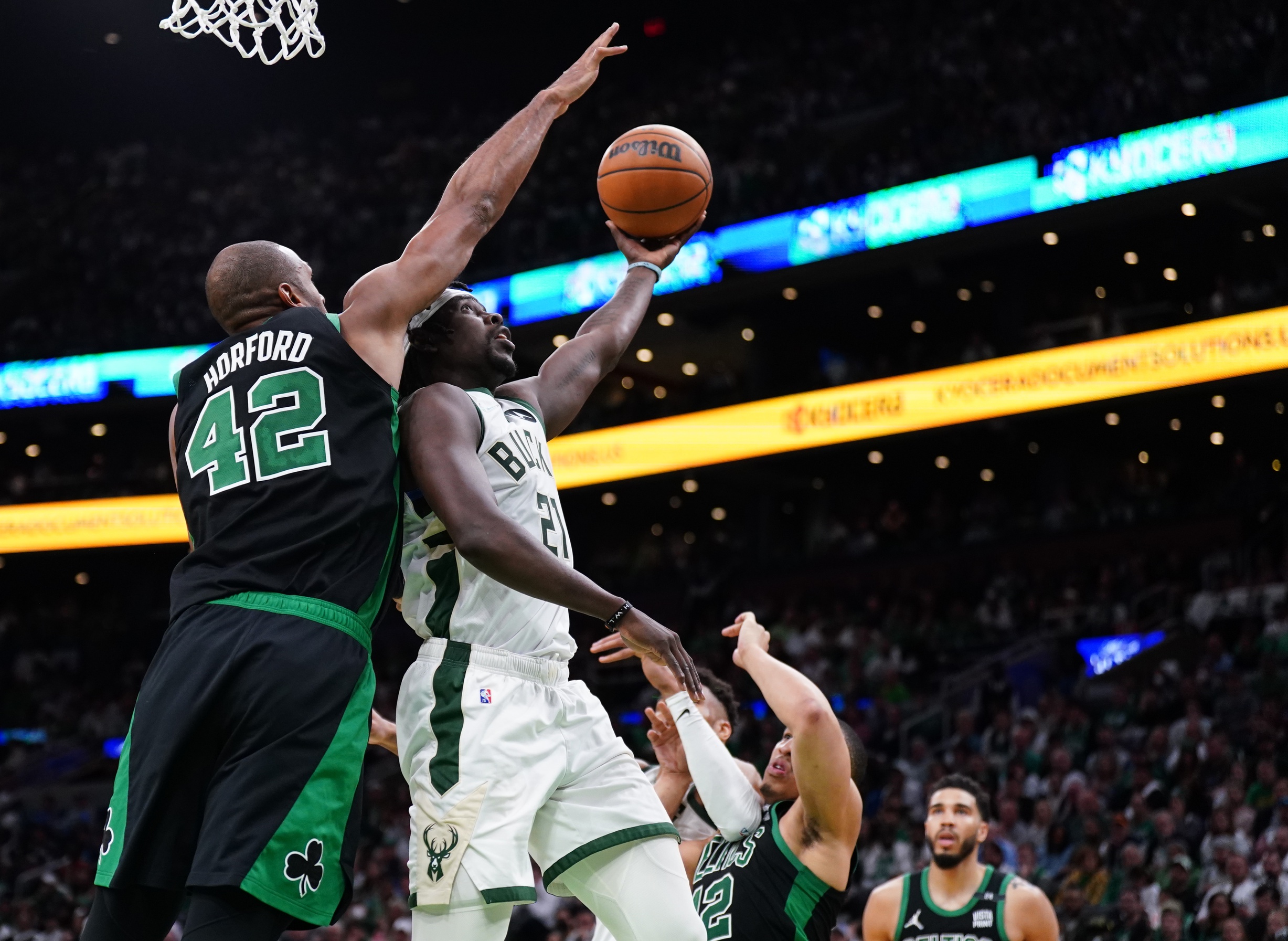 Milwaukee Bucks guard Jrue Holiday (21) shoots against Boston Celtics center Al Horford (42) in the second half during game one of the second round for the 2022 NBA playoffs at TD Garden.