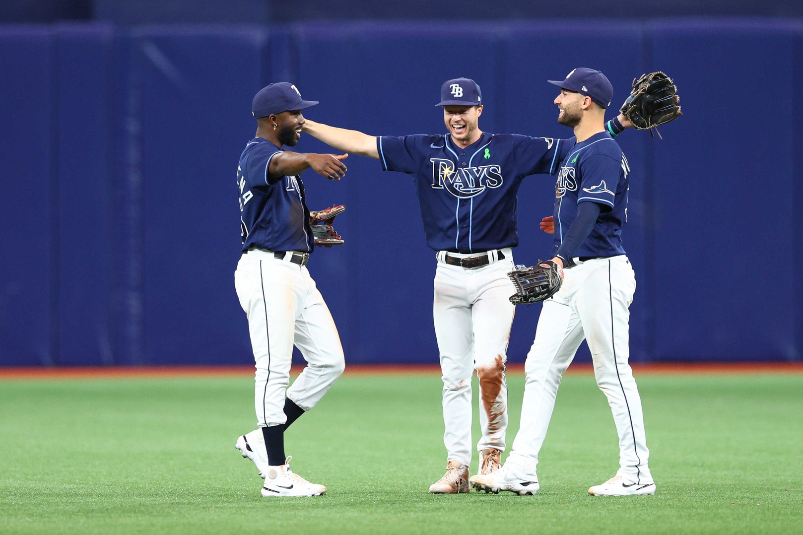 Tampa Bay Rays right fielder Brett Phillips (35) celereates with center fielder Kevin Kiermaier (39) (right) and left fielder Randy Arozarena (56) (left) after beating the Detroit Tigers at Tropicana Field.