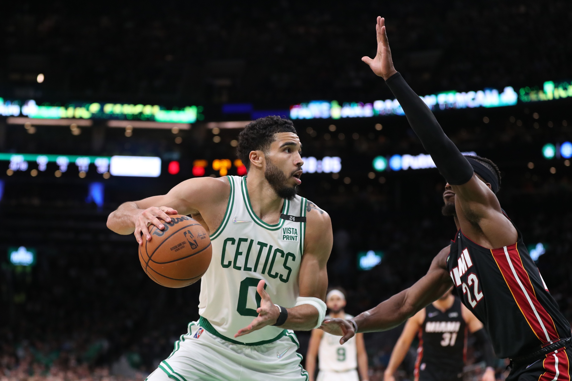 Boston Celtics forward Jayson Tatum (0) looks to move the ball defended by Miami Heat forward Jimmy Butler (22) in the second half during game four of the 2022 eastern conference finals at TD Garden.