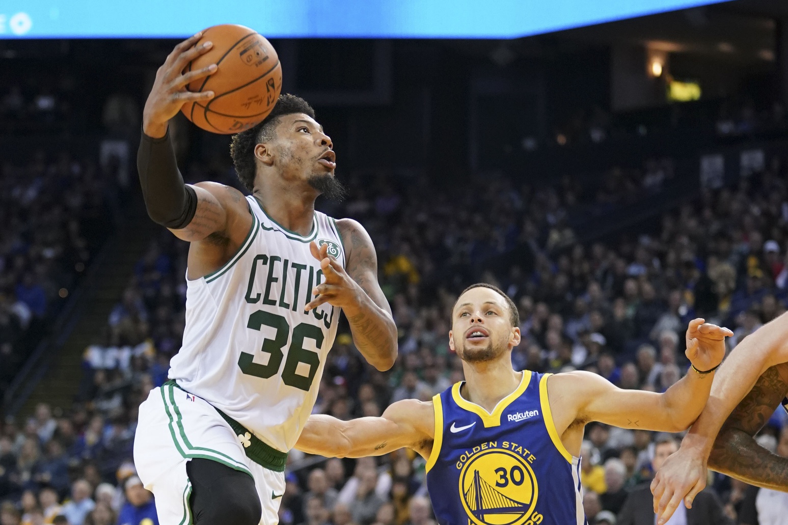Boston Celtics guard Marcus Smart (36) shoots the basketball against Golden State Warriors guard Stephen Curry (30) during the third quarter at Oracle Arena.