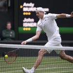 John Isner (USA) returns a shot during his second round match against Andy Murray (GBR) on day three at All England Lawn Tennis and Croquet Club.
