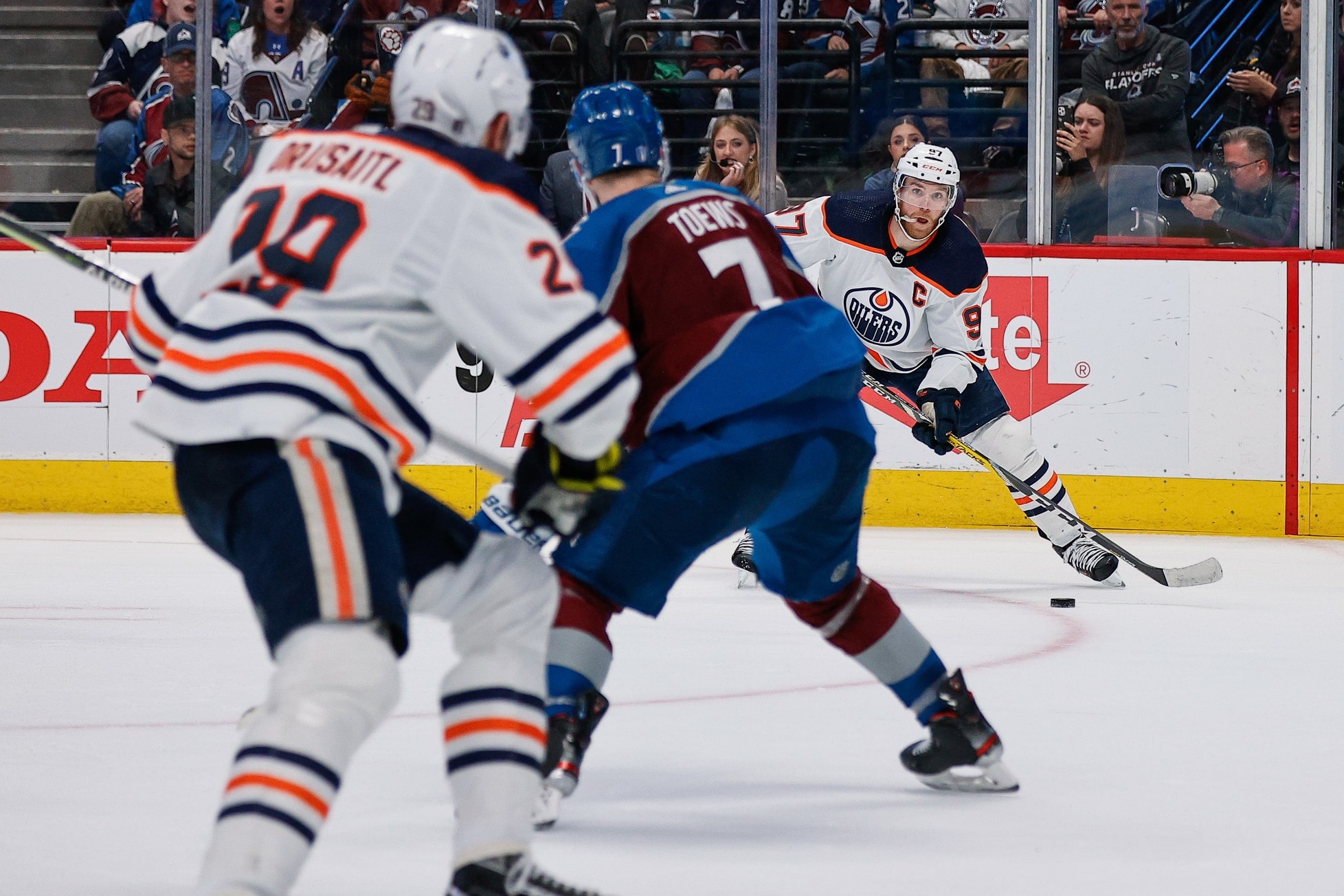 Edmonton Oilers center Connor McDavid (97) looks to pass the puck to center Leon Draisaitl (29) as Colorado Avalanche defenseman Devon Toews (7) defends in the third period in game one of the Western Conference Finals.