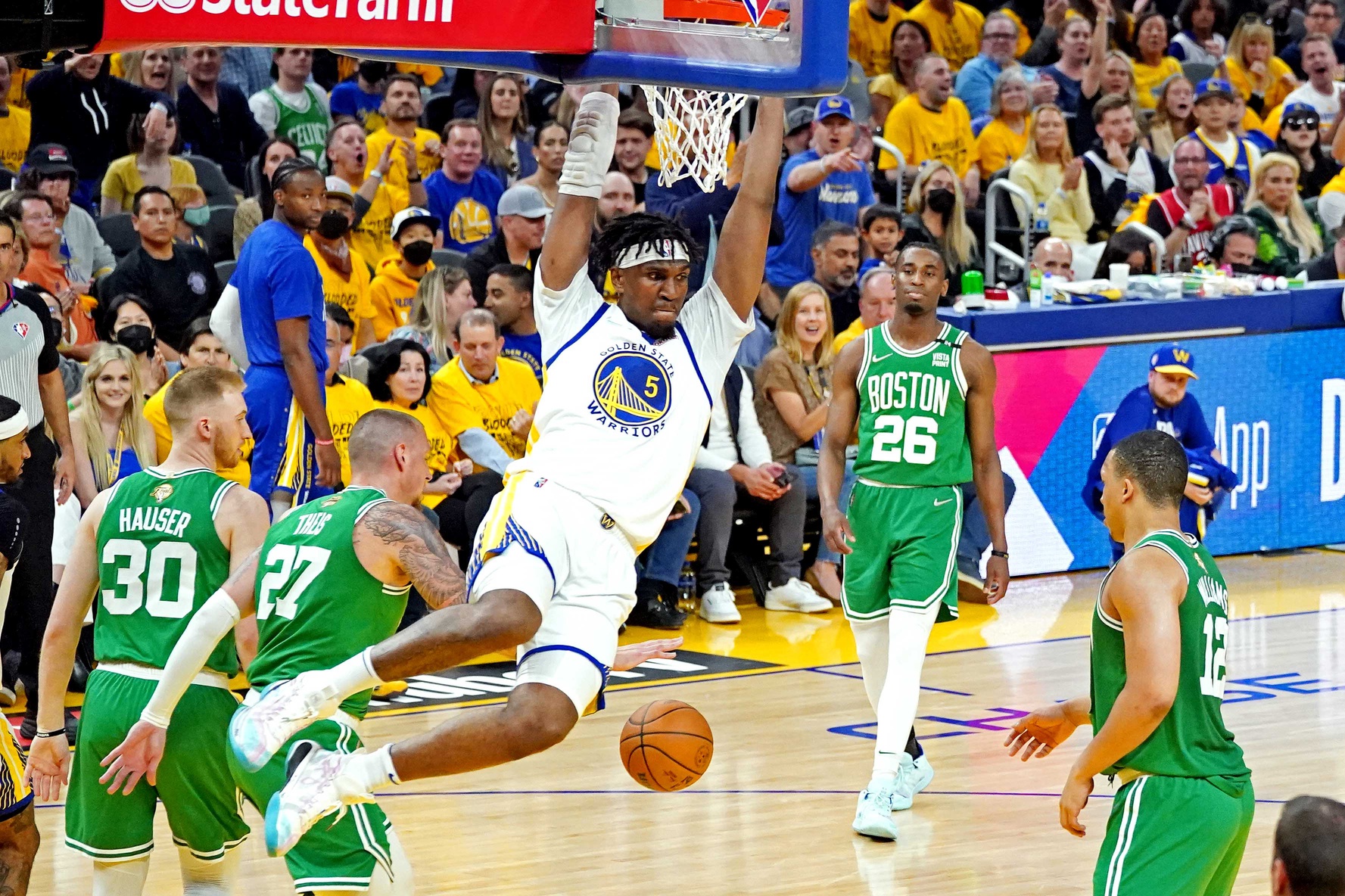 Golden State Warriors center Kevon Looney (5) dunks the ball against Boston Celtics center Daniel Theis (27) during game two of the 2022 NBA Finals at Chase Center.