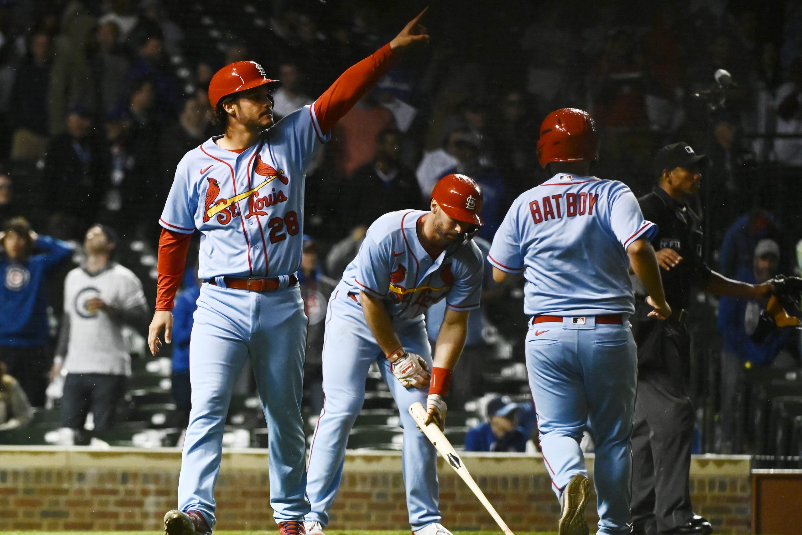 St. Louis Cardinals third baseman Nolan Arenado (28) points towards third baseman Brendan Donovan (not pictured) after scoring on a RBI double by Donovan against the Chicago Cubs in the tenth inning at Wrigley Field.