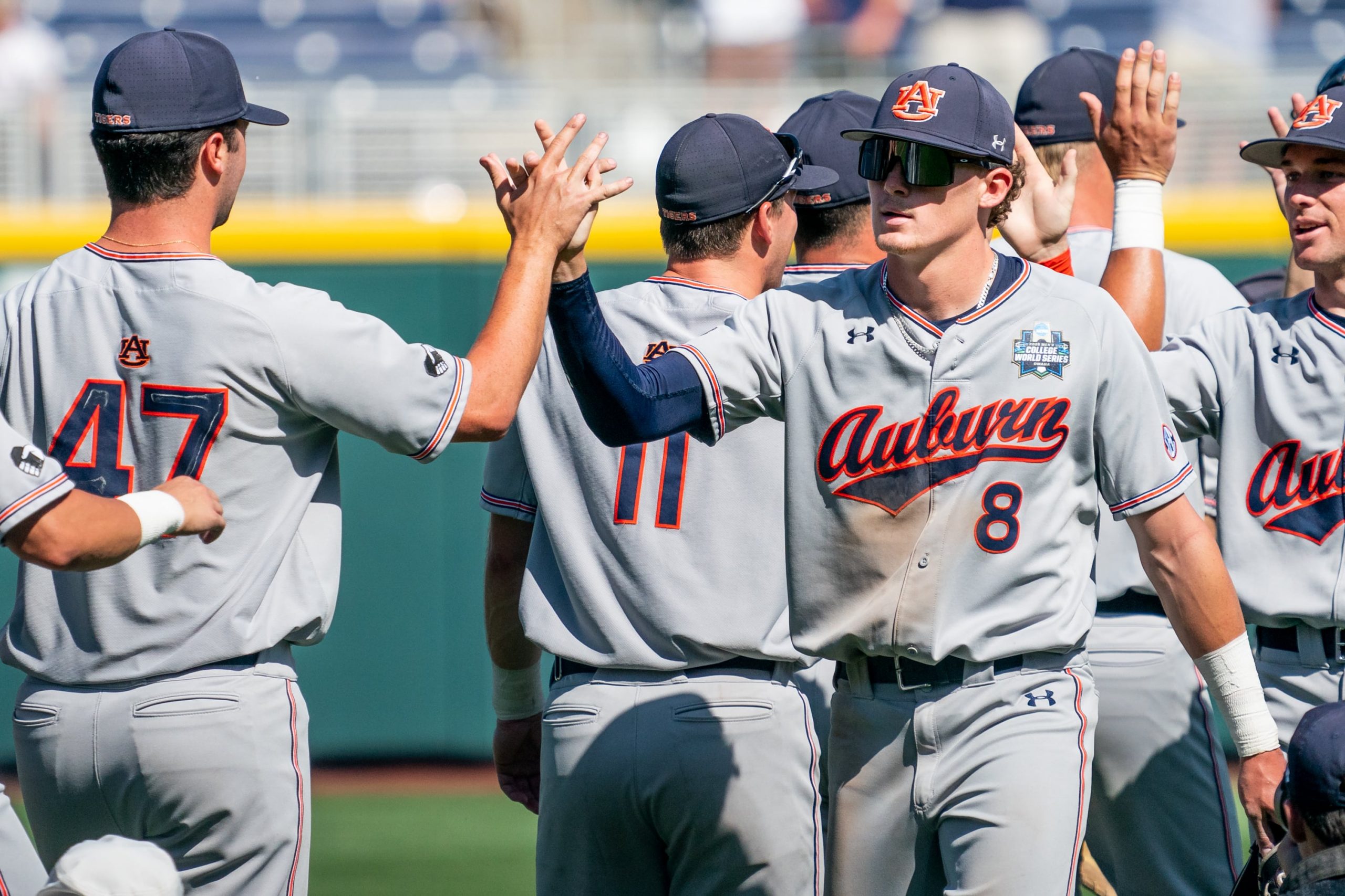 Auburn Tigers infielder Bryson Ware (8) high fives infielder Tommy Sheehan (47) after defeating the Stanford Cardinal at Charles Schwab Field.