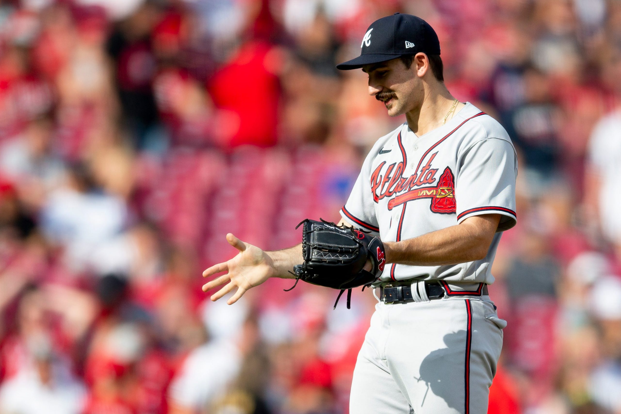 Atlanta Braves starting pitcher Spencer Strider (65) speaks to the umpire in the fifth inning of the MLB game between the Cincinnati Reds and the Atlanta Braves at Great American Ball Park in Cincinnati on Saturday, July 2, 2022