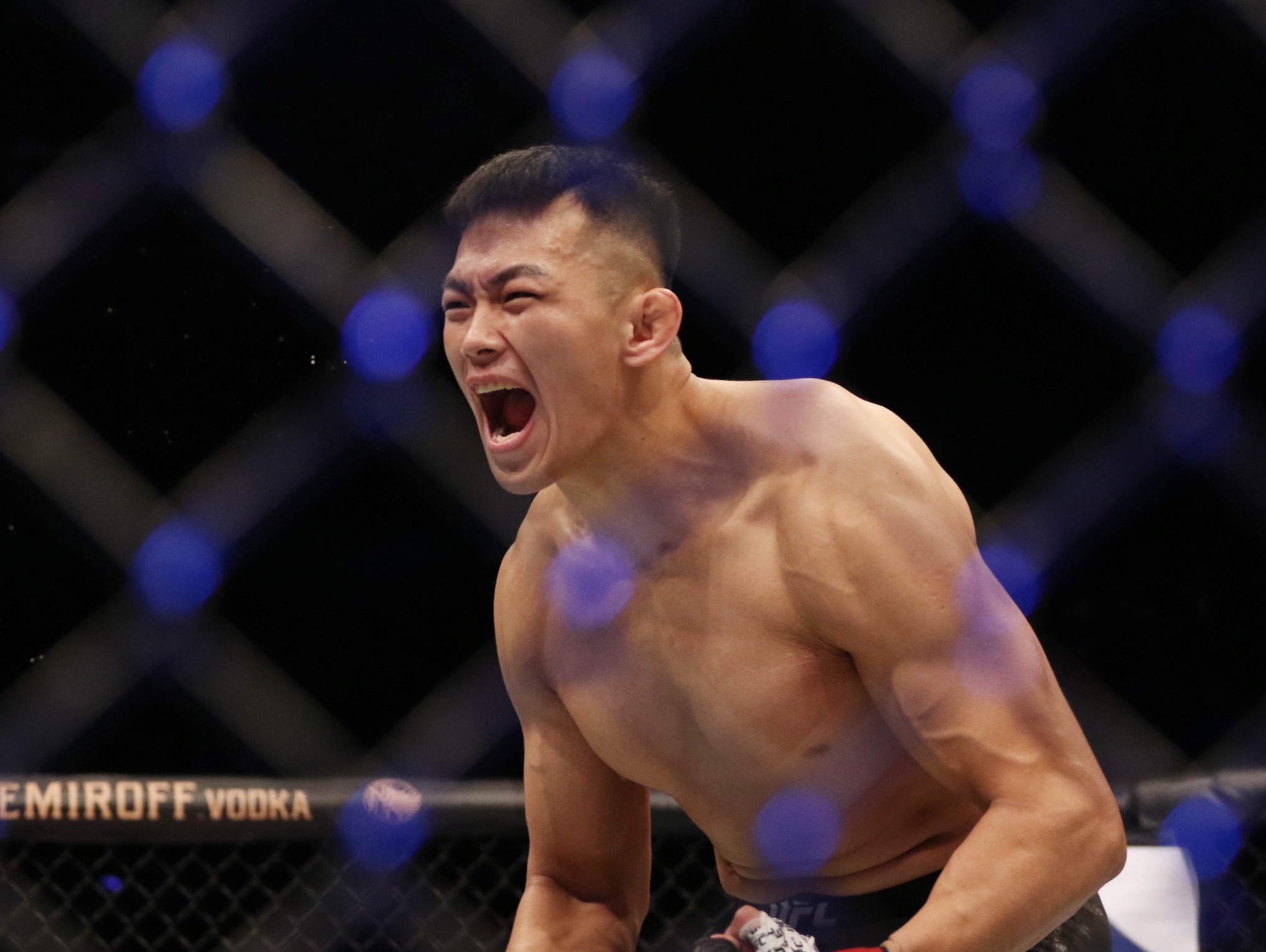 Da Un Jung (red gloves) defeats Mike Rodriguez (blue gloves) during UFC Fight Night at Sajik Arena.