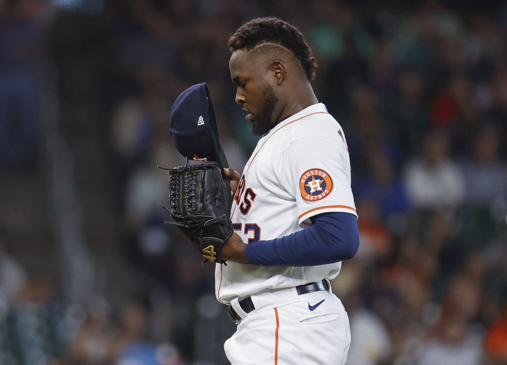 Houston Astros starting pitcher Cristian Javier (53) looks in his cap during the third inning against the Cleveland Guardians at Minute Maid Park.