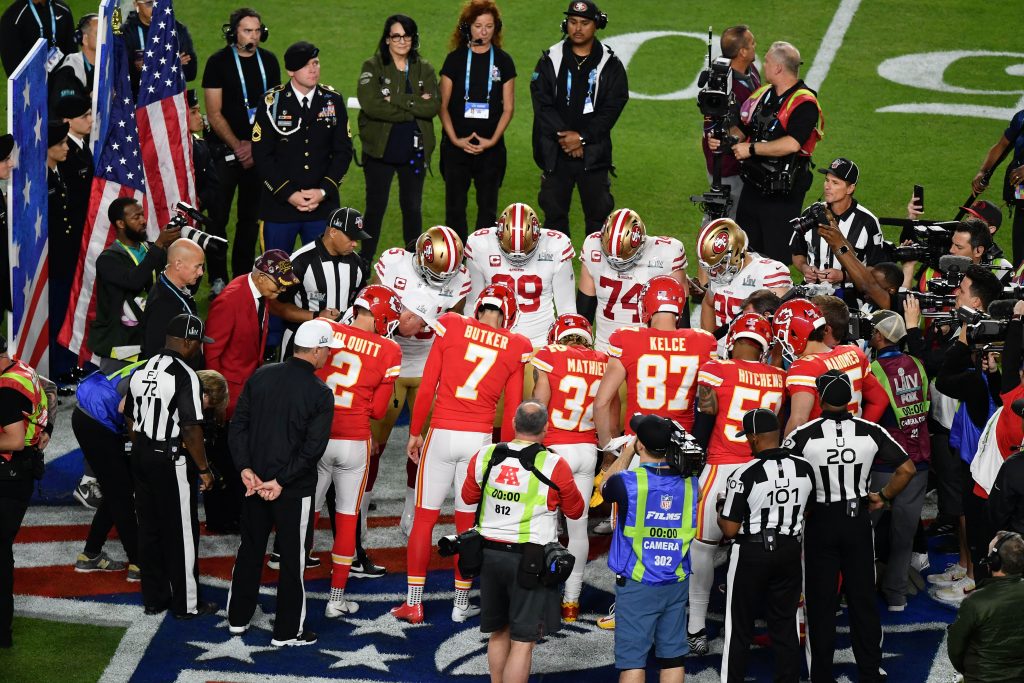 San Francisco 49ers and Kansas City Chiefs stand on the 50 yard line for the coin toss prior to the game between the San Francisco 49ers and the Kansas City Chiefs in Super Bowl LIV at Hard Rock Stadium.